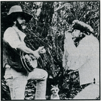 Ray Owen in frontier clothing, playing guitar and harmonica, depicting Davy Crockett and Daniel Boone